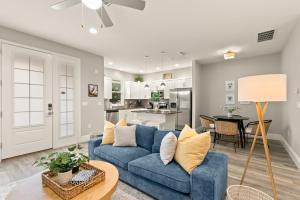 a living room with a blue couch and a table at NEW! Canopy Cabana - Luxury Downtown Apartment in Safety Harbor