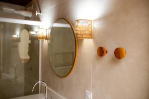 a bathroom with a mirror and a sink at Pousada Valhacouto in Paraty