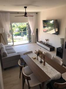 a living room with a table and a couch at Modern condo close to Rodney Bay and Airport in Gros Islet