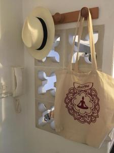 a tote bag with a hat and some toilet paper at Appart sympa dans le vieux Nimes in Nîmes