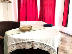 a table with a basket on it with red curtains at Apartment Elizabeth 2 in Košice