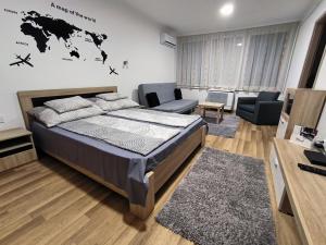 a bedroom with a bed and a living room at Agria Residence in Eger