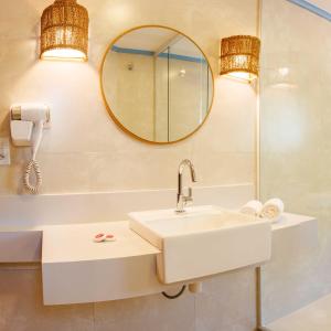 a bathroom with a sink and a mirror at Pousada Valhacouto in Paraty