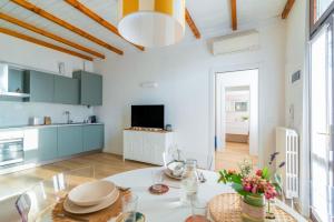a kitchen and living room with a table and chairs at La Corte 48 - Pavia City - by Host4U in Pavia