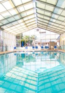 una gran piscina con sillas azules. en 1BR Deluxe Grand Palms Resort Free Shuttle service, en Myrtle Beach