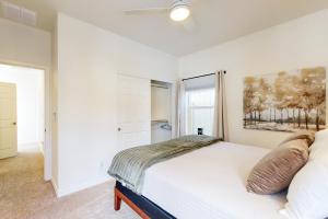 a white bedroom with a bed and a window at Ponderosa Peaks Retreat in Flagstaff