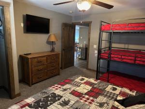 a bedroom with two bunk beds and a television at Table Rock Resorts at Indian Point in Branson