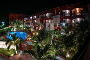 an aerial view of a hotel with a pool and palm trees at Hotel Zihua Caracol in Zihuatanejo