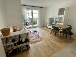 uma sala de estar com uma mesa e uma sala de jantar em Cozy Apartment Near the Train Station em Rueil-Malmaison
