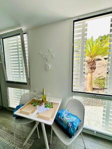 a dining room with a table and chairs and a window at AMBER APARTMENTS - FRESH STUDIO in Morro del Jable