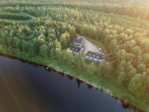 an aerial view of a house in the middle of a lake at Gold Digger's Timber in Inari