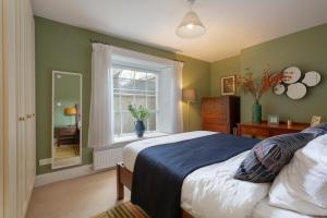 a bedroom with a large bed and a window at Spectacular 2 Bedroom Apartment with Sunny Garden & Terrace in Dublin