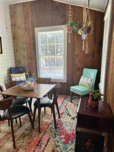 a dining room with a wooden table and chairs at Wensel Cottage in downtown Natchez in Natchez +25 photos
