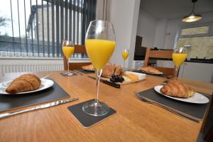 a table topped with glasses of orange juice and croissants at Sedgemoor in Stockton-on-Tees