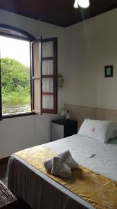 Cama ou camas em um quarto em Pousada Siroba BEIRA RIO
