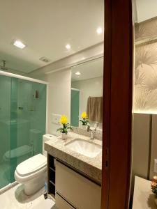 a bathroom with a sink and a toilet and a mirror at EXCLUSIVE RESIDENCE, BARRA GRANDE, PENINSULA DE MARAÚ in Barra Grande