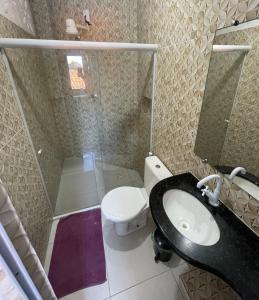 a bathroom with a shower and a toilet and a sink at Apartamento a 1 km da Orla in Aracaju