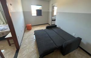 a living room with a black couch in a room at Apartamento a 1 km da Orla in Aracaju