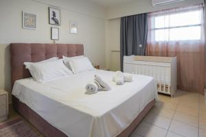 A bed or beds in a room at Theo and MS Luxurious Apartments