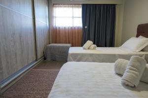 A bed or beds in a room at Theo and MS Luxurious Apartments