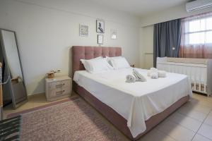 a bedroom with a large bed with two towels on it at Theo and MS Luxurious Apartments in Kos