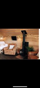 a living room with two couches and a stove at Craster Coastal Cabins in Craster