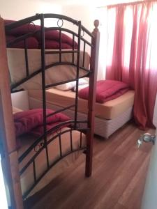 a room with two bunk beds and a ladder to a bunk bed at cabañas de la casona in Punta de Choros
