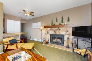 a living room with a fireplace with a tv at Stateline Serenity in Stateline