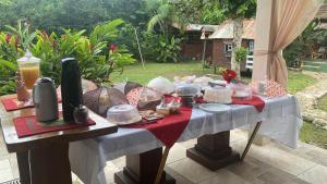 a table with food on top of it at Pousada Siroba Beira Rio in Morretes