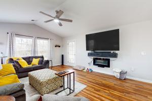 a living room with a couch and a flat screen tv at Our Beach House Retreat in Myrtle Beach
