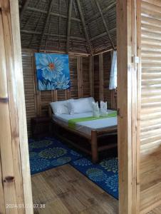 a bedroom with a bed in a room at NATUA'S BEACH RESORT in Liminangcong