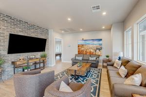 a living room with a tv and a brick wall at Modern Delight-Ocotillo 54 in Santa Clara
