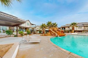 a swimming pool with two lounge chairs and a water slide at Modern Delight-Ocotillo 54 in Santa Clara