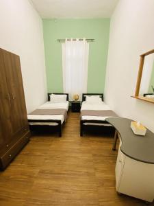 a hospital room with two beds and a desk at City Hostel Dormitory in Tr&acirc;blous