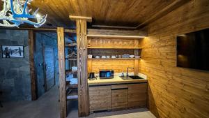 a kitchen with a sink and a microwave at Jasna Boutique Chalet in Liptovský Mikuláš