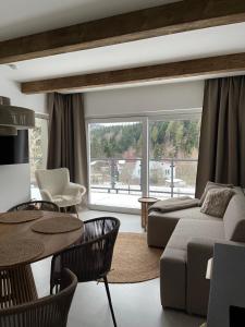 a living room with a couch and a table at Apartament Uzdrowiskowa I Prestige in Szczyrk
