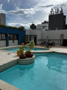 a large swimming pool on top of a building at Amazing Flat - Setor Oeste in Goiânia