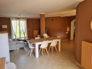 a dining room and living room with a table and chairs at les gites de pietra rossa in Bastia