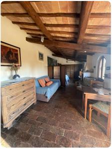 a living room with a blue couch and a table at Sunset and lake in Bolsena +20 photos