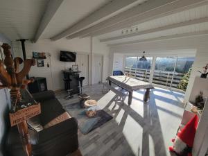a living room with a table and a couch at Bienvenue au CHAT LAIT ! in Seilhac +9 photos