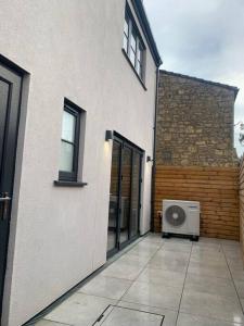 a white building with a window and a washing machine at Modern 2 bedroom property with quirky décor in Chilcompton
