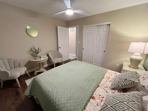 a bedroom with a bed and a chair and a table at A retreat nestled in the heart of NKY in Florence