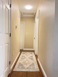 an empty hallway with a rug on the floor at A retreat nestled in the heart of NKY in Florence