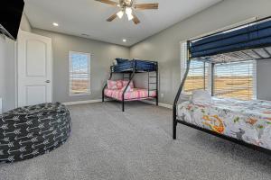 a bedroom with two bunk beds and a ceiling fan at Sunset Valley in Kirk O'Cliff