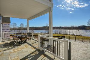 a porch with a table and chairs and a view of the water at Sunset Valley in Kirk O'Cliff