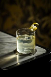 a glass of water with a lemon on a table at The Evelyn NoMad in New York