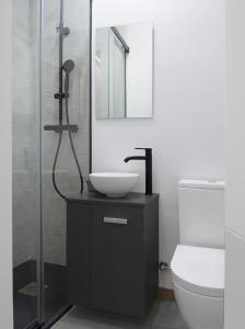 a bathroom with a sink and a shower at El Rincón de la estación in Ourense