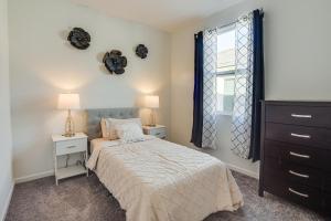 a bedroom with a bed and two night stands and a window at Rio Rancho Home Near Santa Ana Casino and Golf! in Rio Rancho