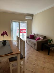 a living room with a couch and a table at 21 on Pescadores T2 in Carvoeiro