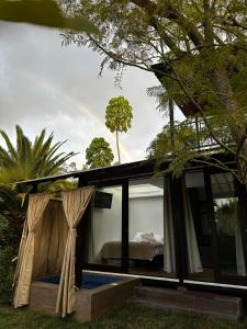 a guest house with a bed in a room at Suite Puembo Bella Stella in Quito